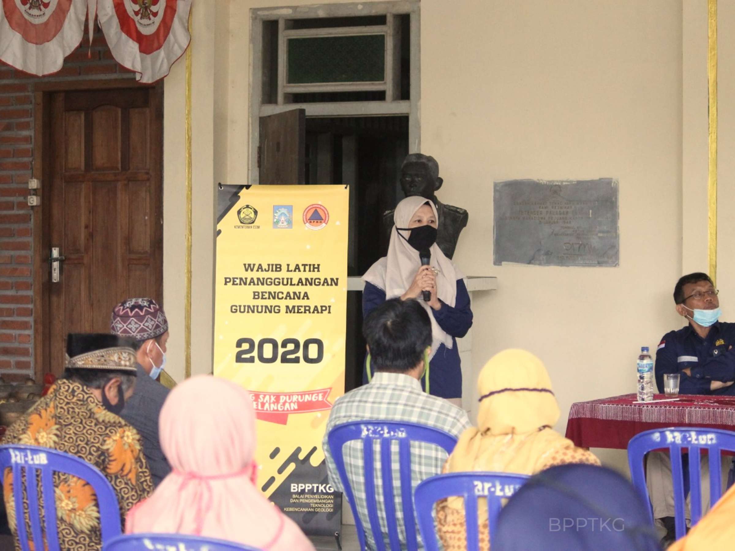 indonesian woman presents in front of a group